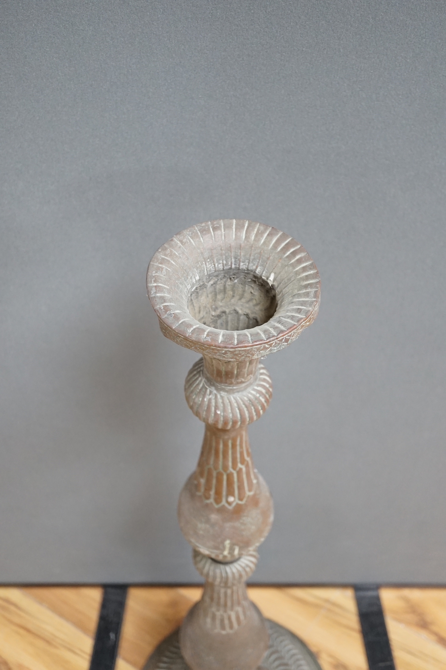 An Islamic copper candle stand, 19th/early 20th century, 97cm high
